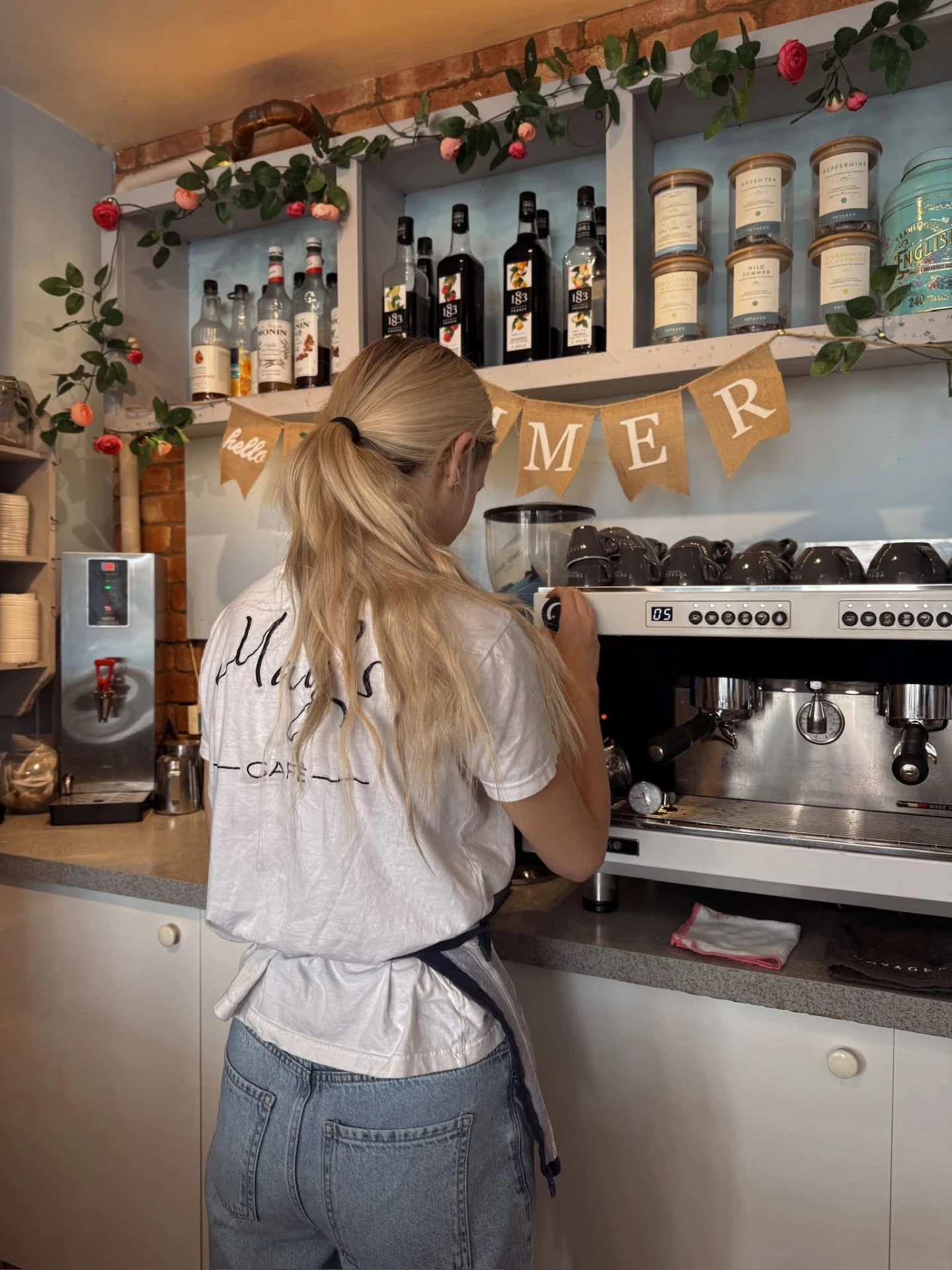 One of the May's Café team making coffee at the espresso machine
