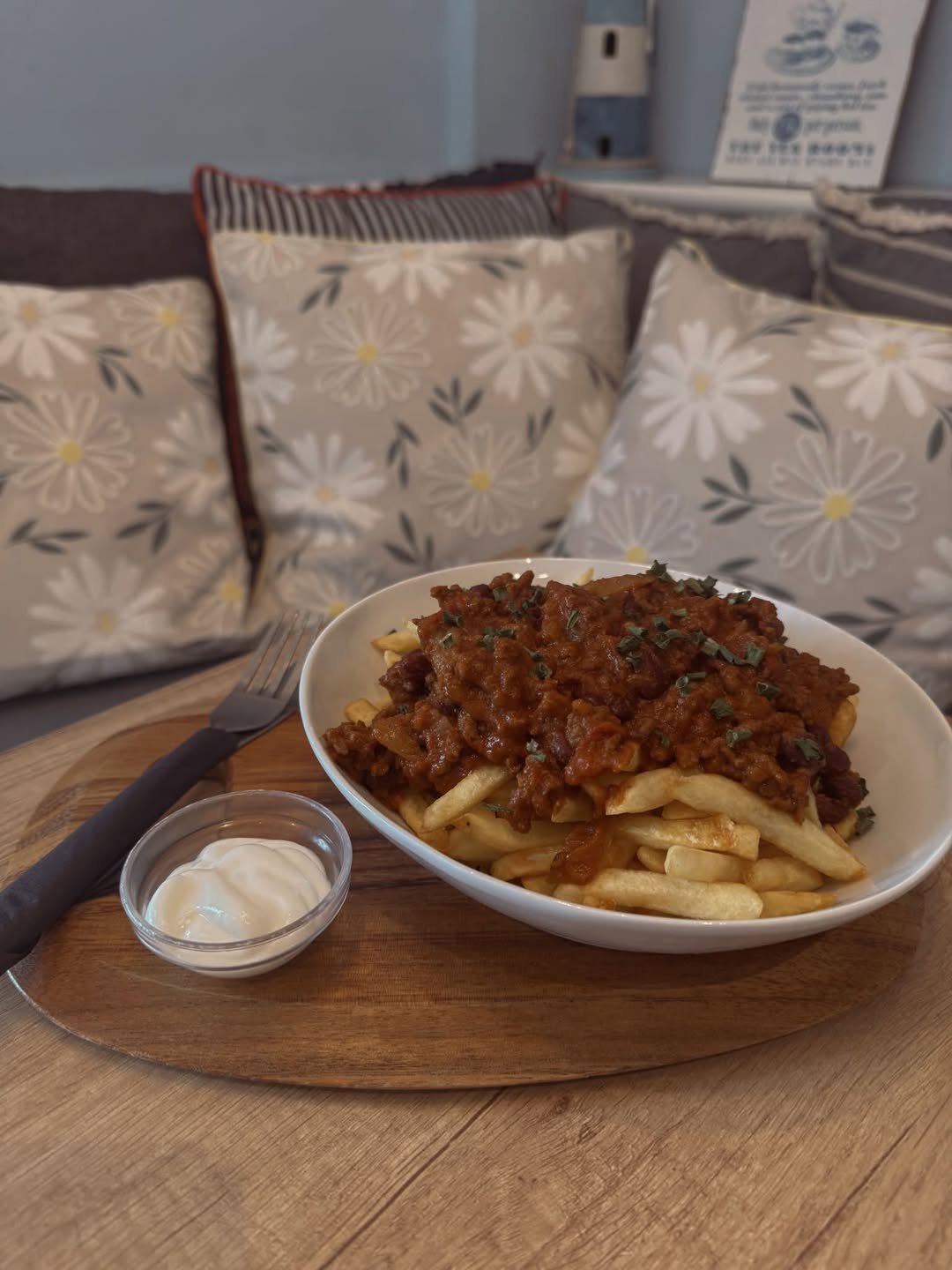Homemade chili con carne loaded fries with sour cream